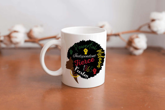 An image of a white ceramic mug featuring the side profile silhouette of an Afro-American woman. Within the silhouette of her Afro are the words ‘powerful,’ ‘independent,’ ‘fearless,’ ‘melanin,’ and the year ‘1865’ to celebrate and remember Juneteenth. - BozzUp Kustomz