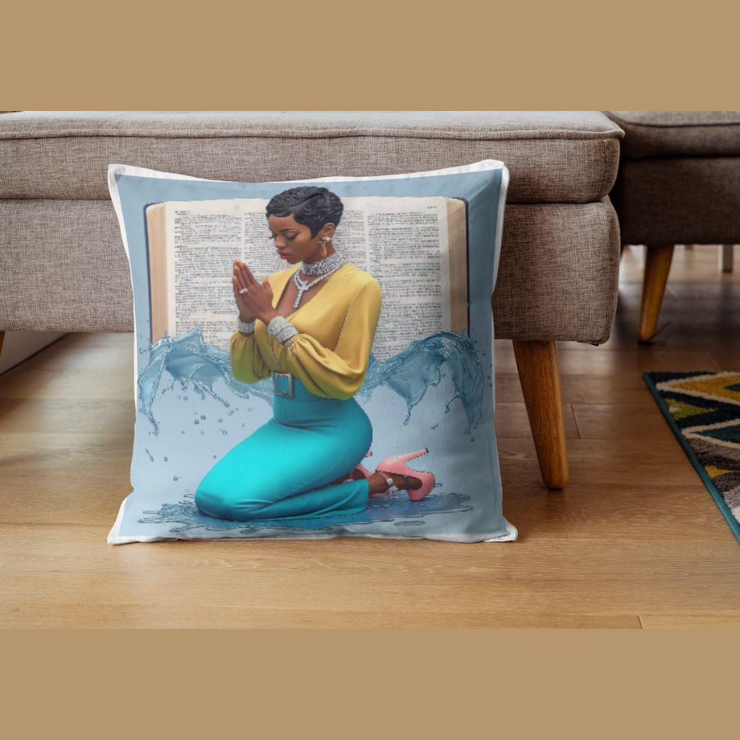 16x16 inch throw pillow with image of african American women with a cute short pixie haircut, wearing yellow blouse and teal pencil skirt, and silver diamond jewelry. the woman is kneeling with open prayer hands, open bible in the background with an accent of splashing water, 3d effect